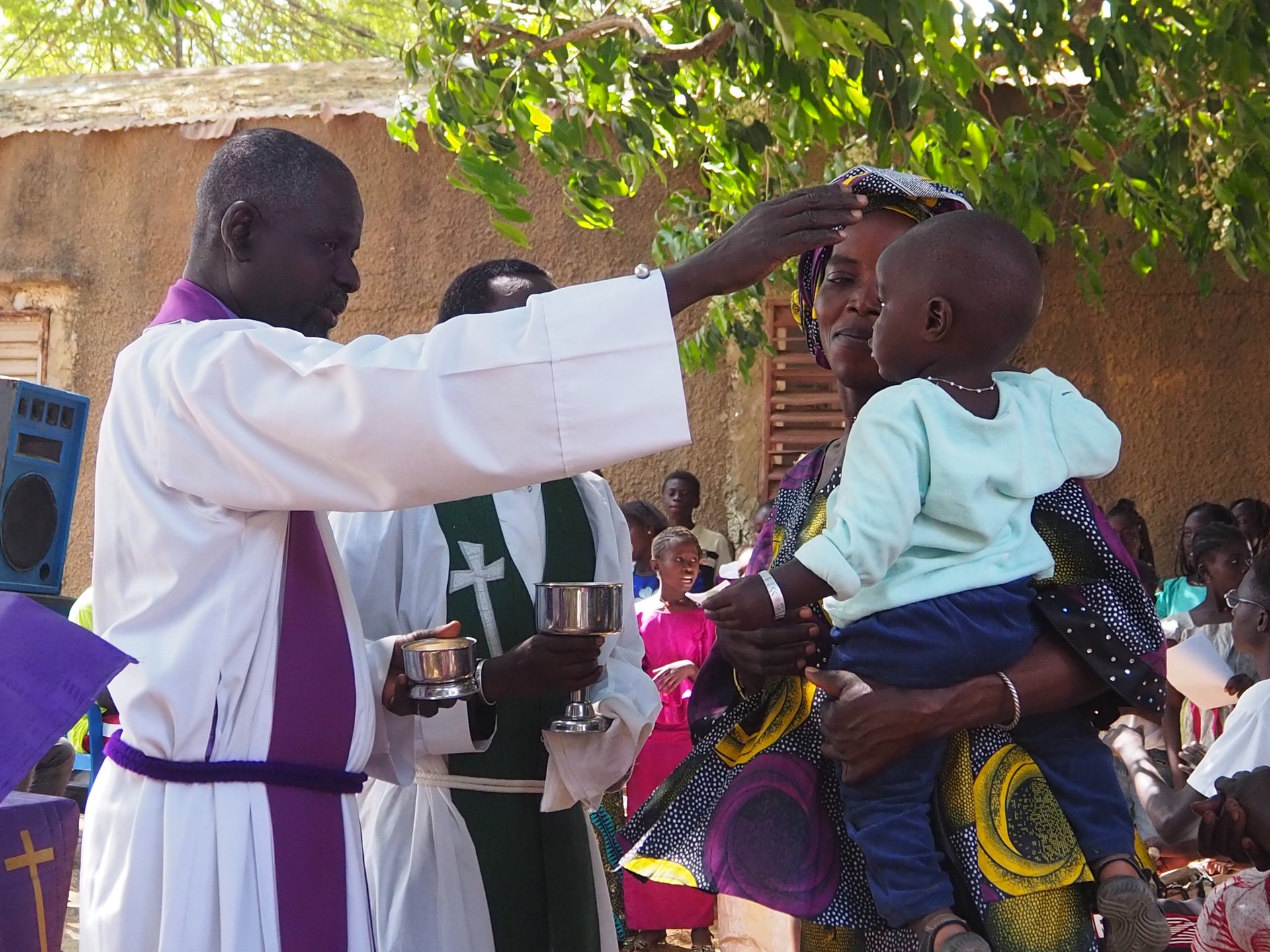 Pastor Moussa Marone of the Mbour congregation blesses a child during Holy Communion.